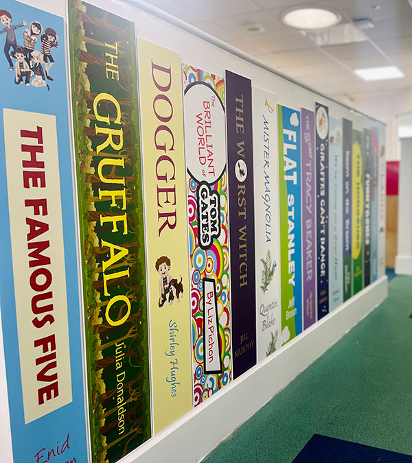 Book spine wall graphics for schools showing various book spine designs