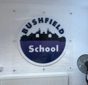 Acrylic logo sign fitted on a wall at a Junior School