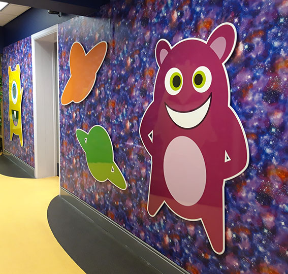 Dojo and space theme wall signs at a Junior school