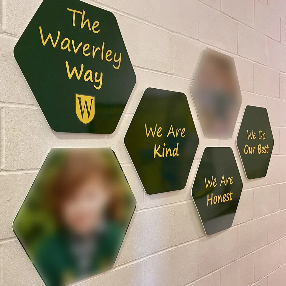 Bespoke hexagon school values wall signs for Waverley Prep School, featuring the school logo, pupil photography, and core values.