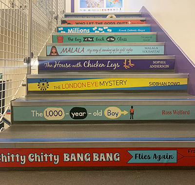 Various design book spine stair graphics on steps at a school