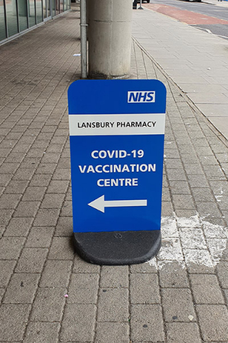 Vaccination Centre signage pavement sign stand directing patients to site