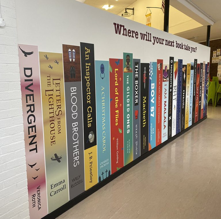 Book spine wall graphics on a school wall