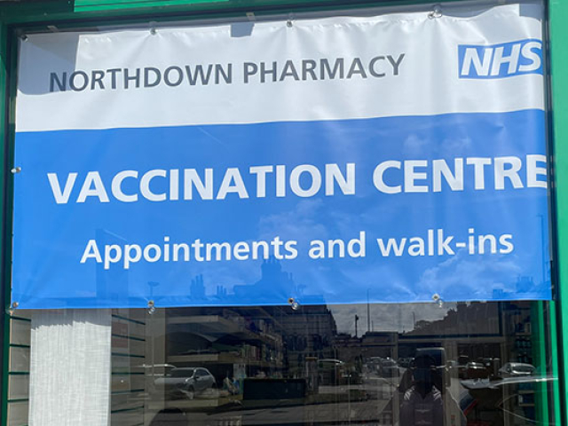 Pharmacy Vaccination Centre displaying a PVC banner in the window promoting the Vaccination Centre