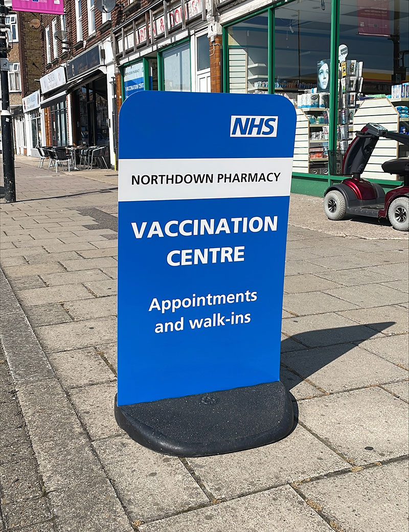 Vaccination Centre pavement stand outside a Pharmacy