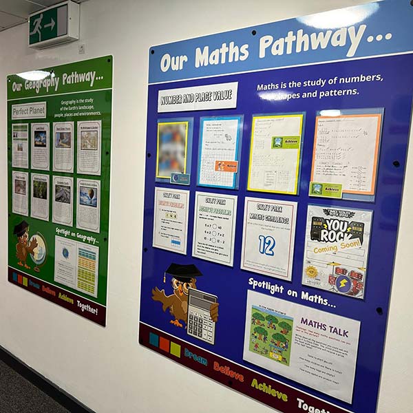 Corridor information display boards for maths and geography subjects on display in a school corridor. With poster pocket holders to easily change content regularly