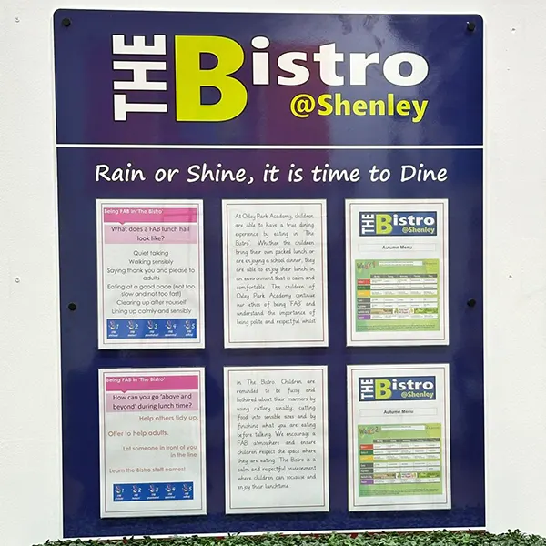 Information display board with acrylic poster holders showing canteen menu options