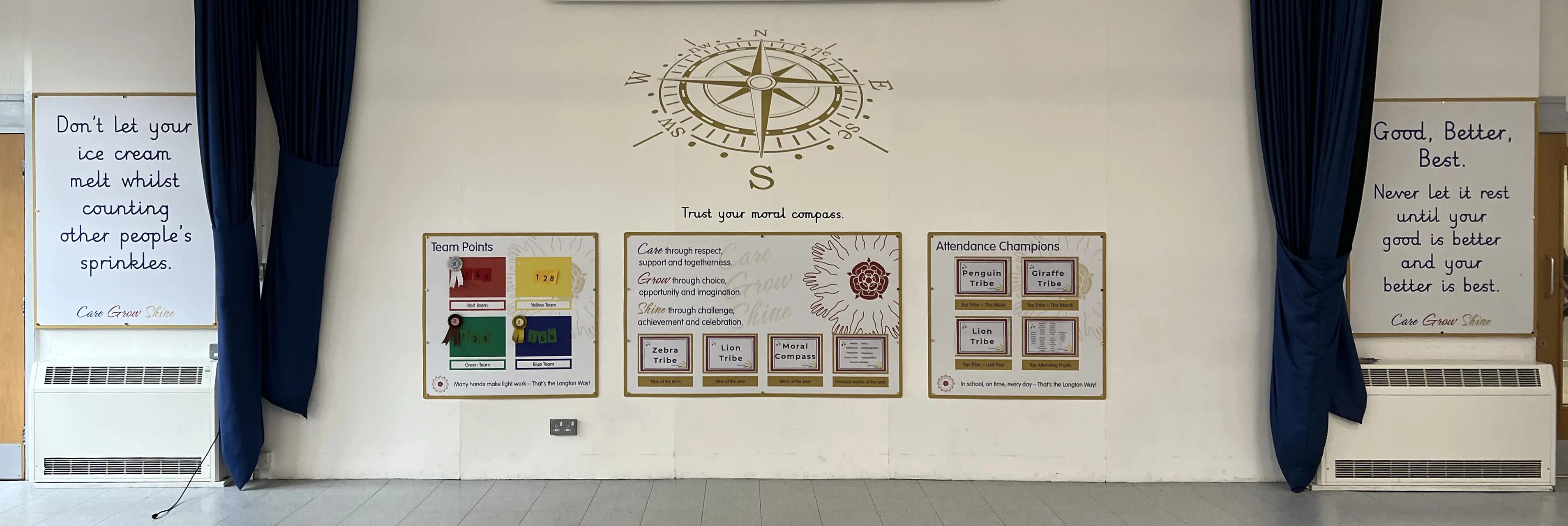 Corridor information display boards on display in a primary school hall. Displaying house and attendance information in acrylic holders which allow the display to be easily updated
