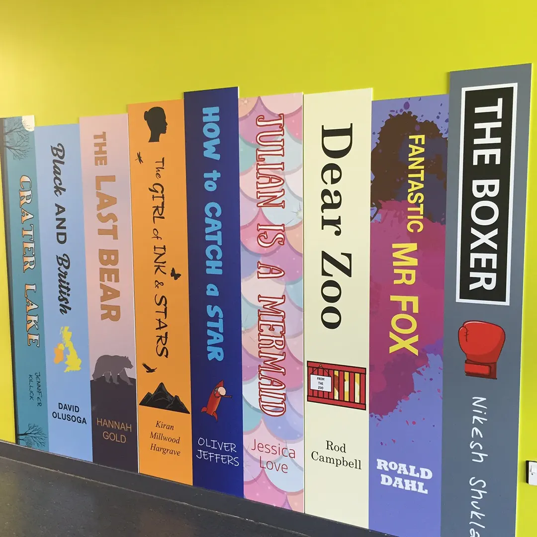 Ellesmere College library wall with custom book spine graphics and literacy displays