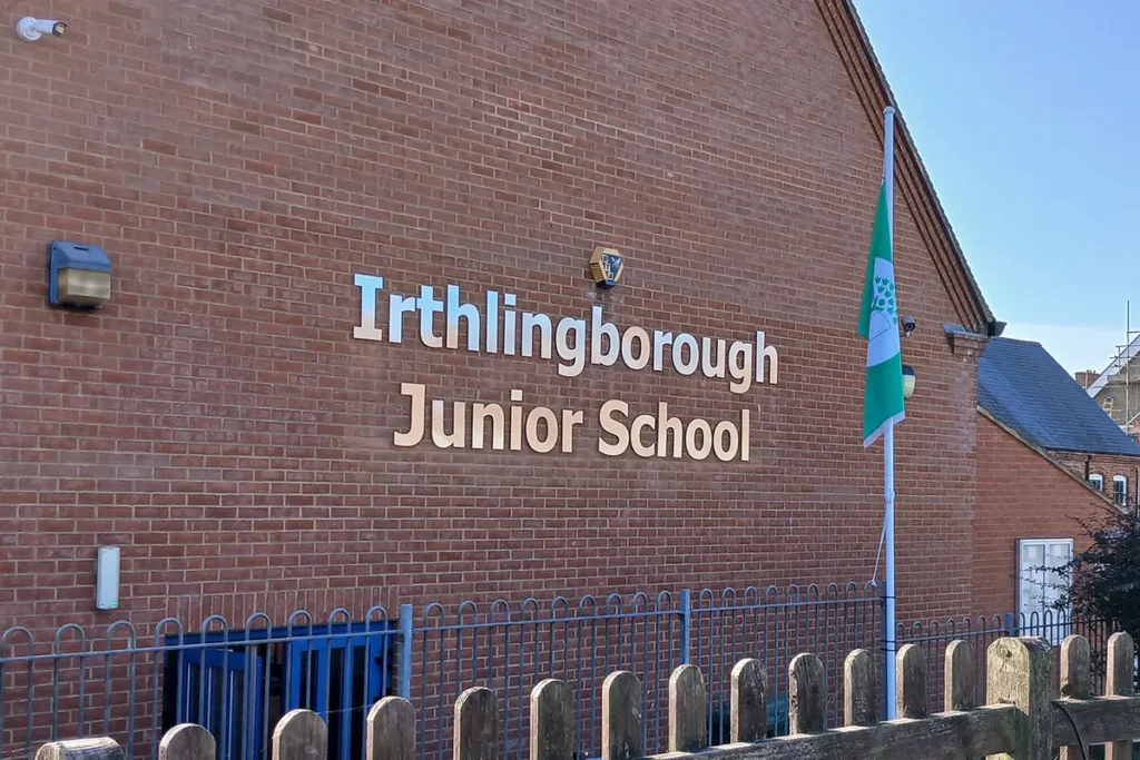 School name sign consisting of stainless steel individual cut lettering - Irthlingborough Junior School