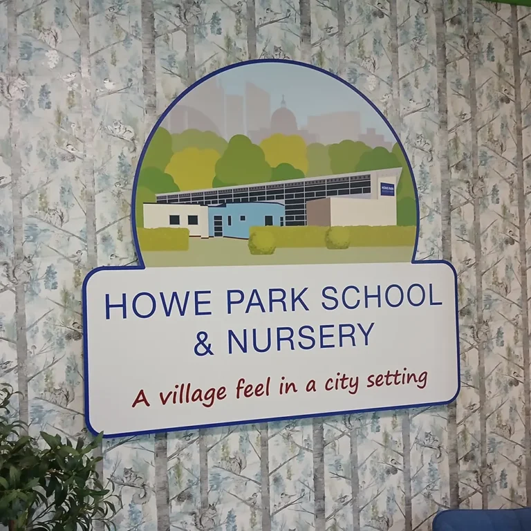 reception-entrance-sign-howe-park-school-milton-keynes Shaped school logo sign fitted on the main wall in reception with a patterned wallpaper behind it - Howe Park School, Milton Keynes