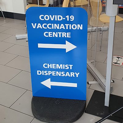 Covid-19 vaccination centre pavement stand signage for a Pharmacy